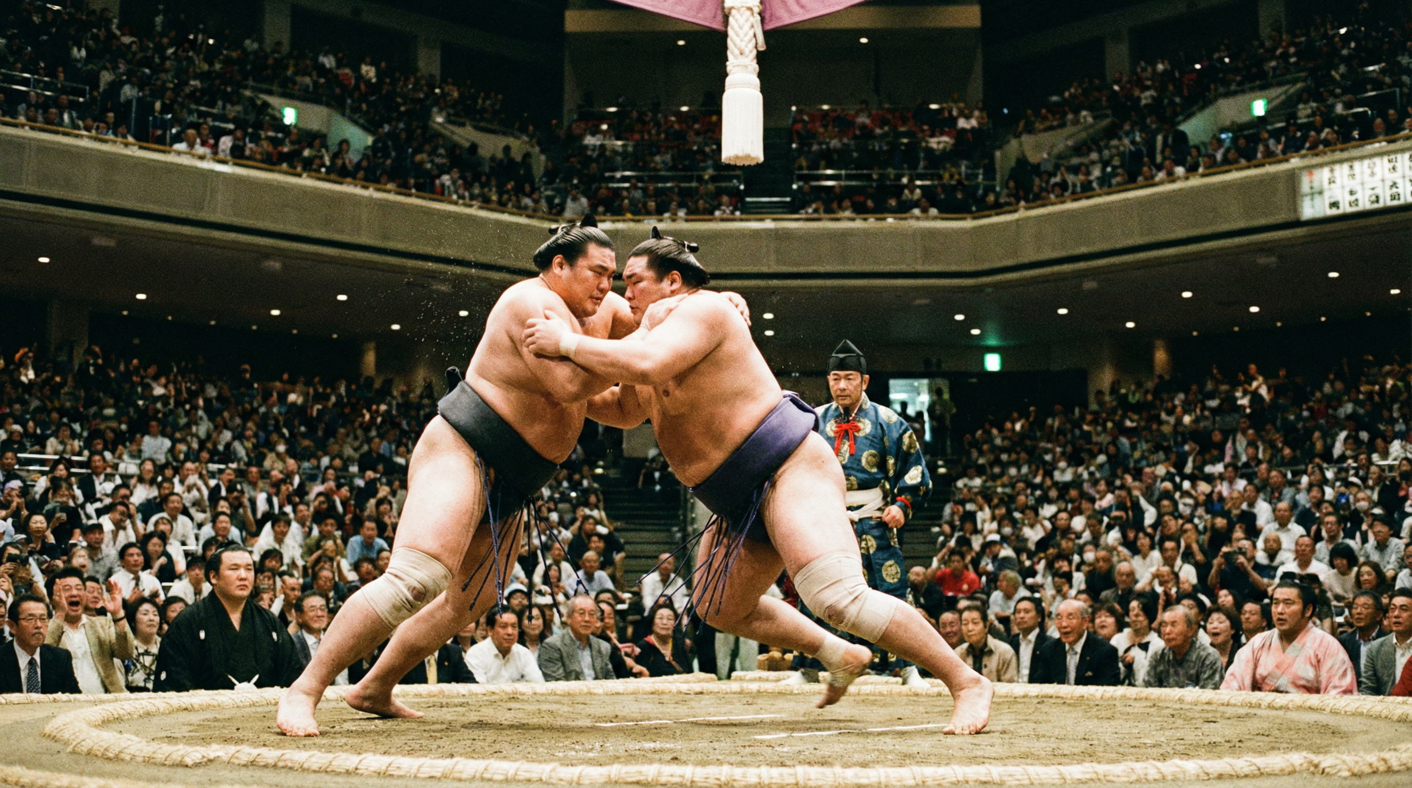 AI generated image using NANO_BANANA_PRO: Two Japanese sumo wrestlers. Competing in an arena. Sports photography.